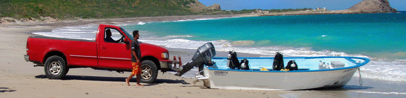 A truck pushes a large panga boat into the Sea of Cortez.